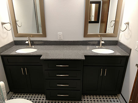 slick looking double vanity with black cabinets